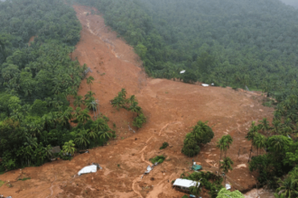 Aerial view of the 2024 Wayanad landslide showing displaced earth and damaged homes on a hillside